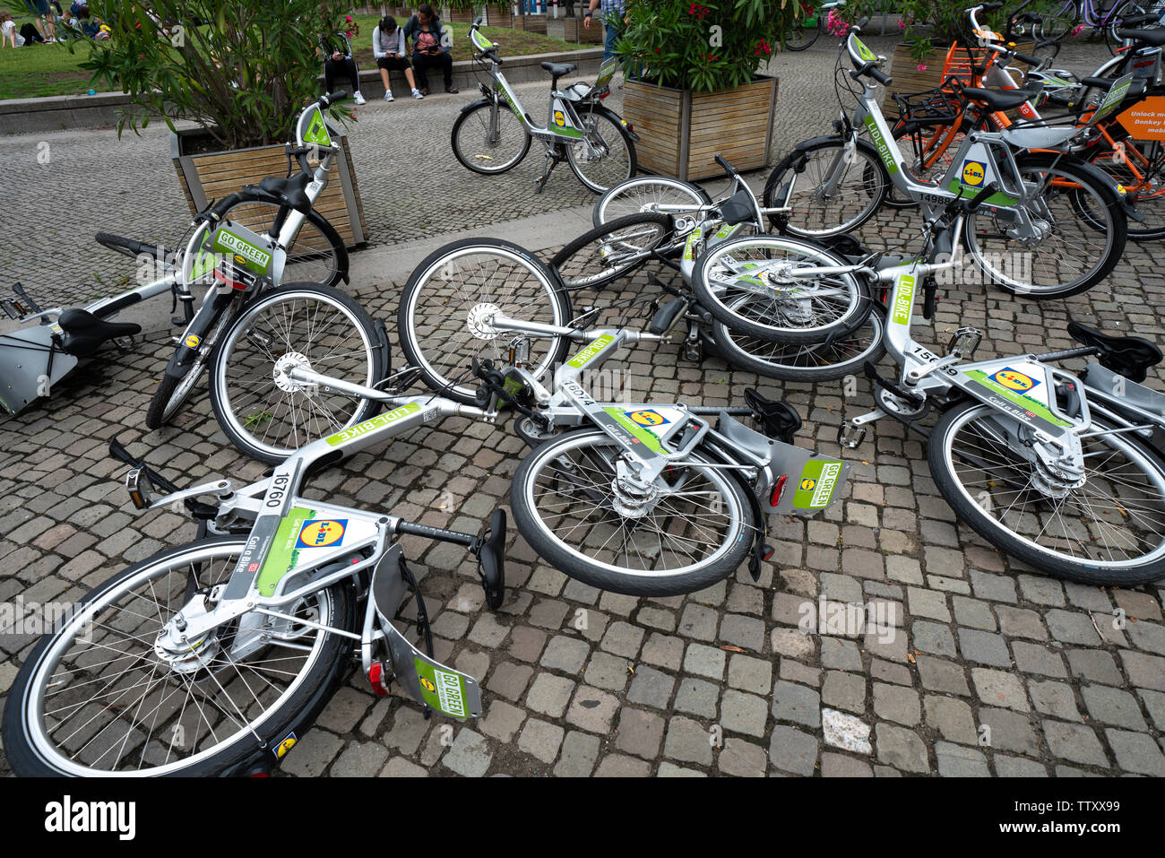 Overturned rental bikes on street in Berlin, Germany Stock Photo
