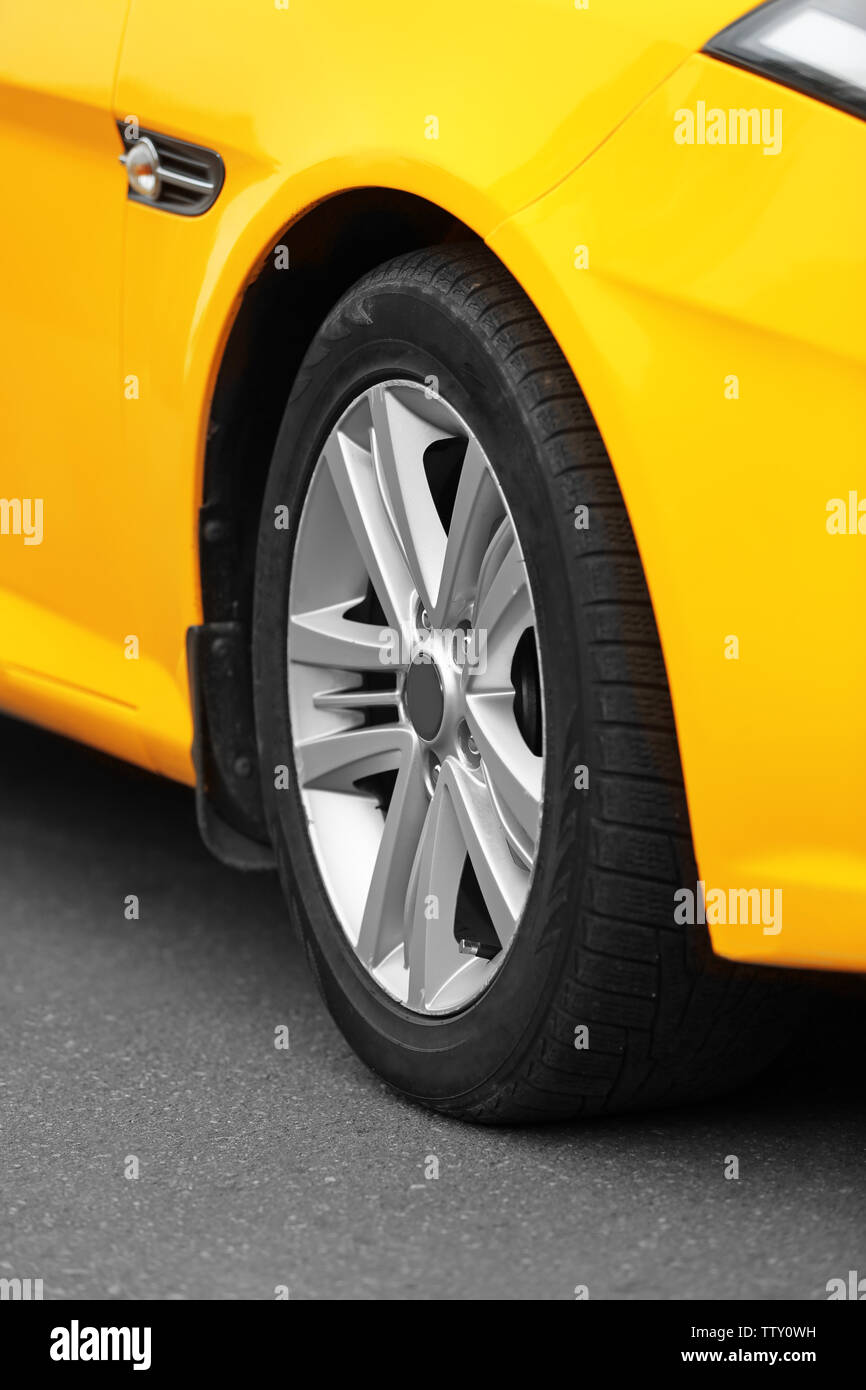 Wheel of yellow car, closeup Stock Photo - Alamy