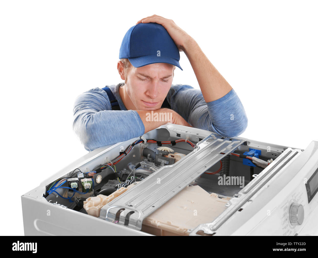 Plumber with washing machine on white background Stock Photo