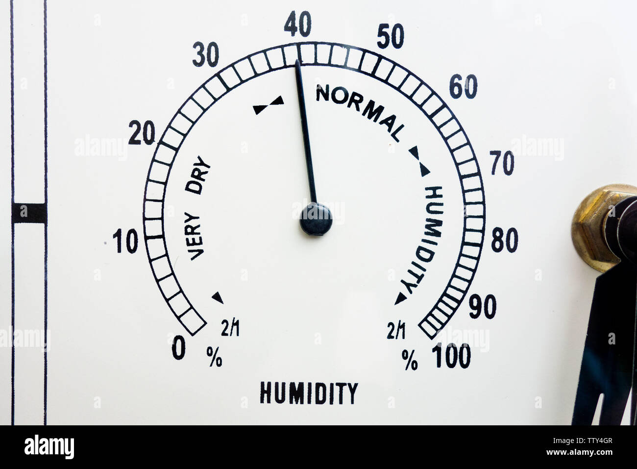 Measurement and control of humidity. Meteo weather indicator hygrometer face with black scale, needle and numbers. Closeup of analog device Stock Photo