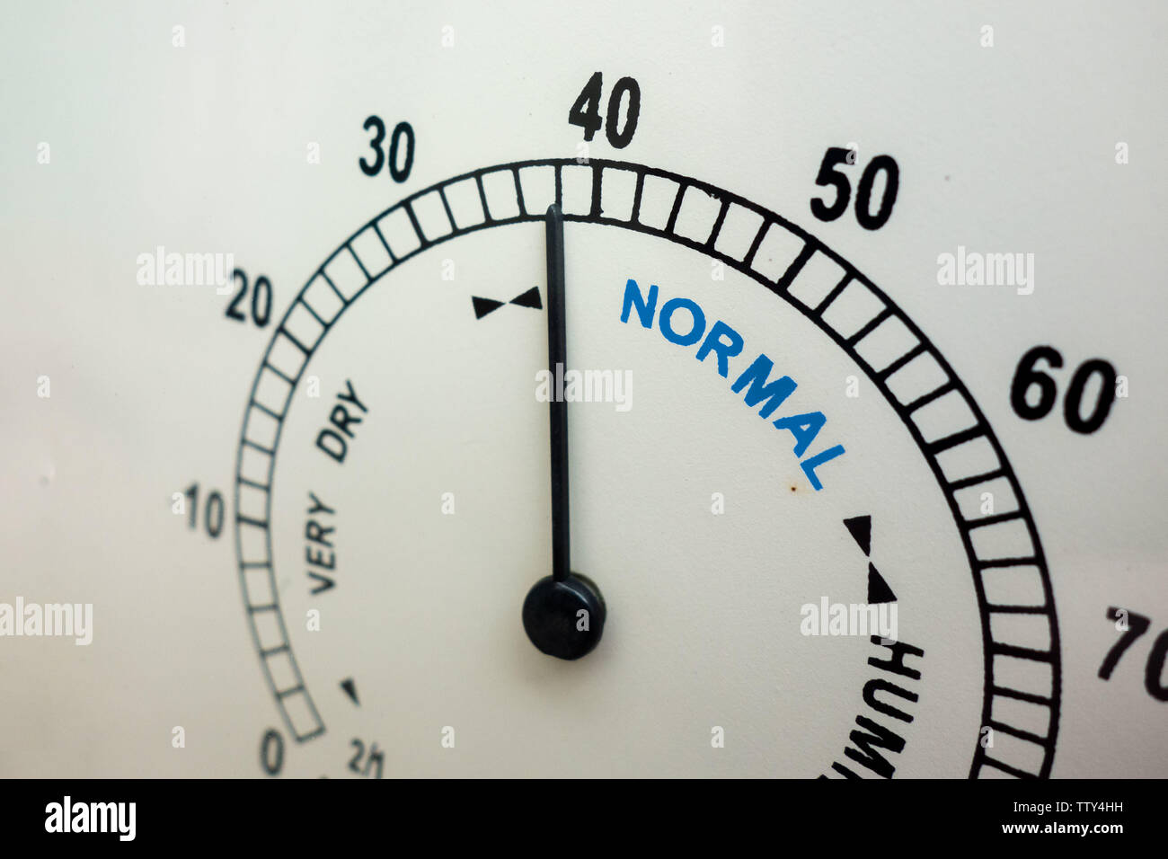 Humidity and weather conditions concept. Face of analog humidity indicator instrument with needle. Normal range is indicated. Humidor or cigar keeping Stock Photo