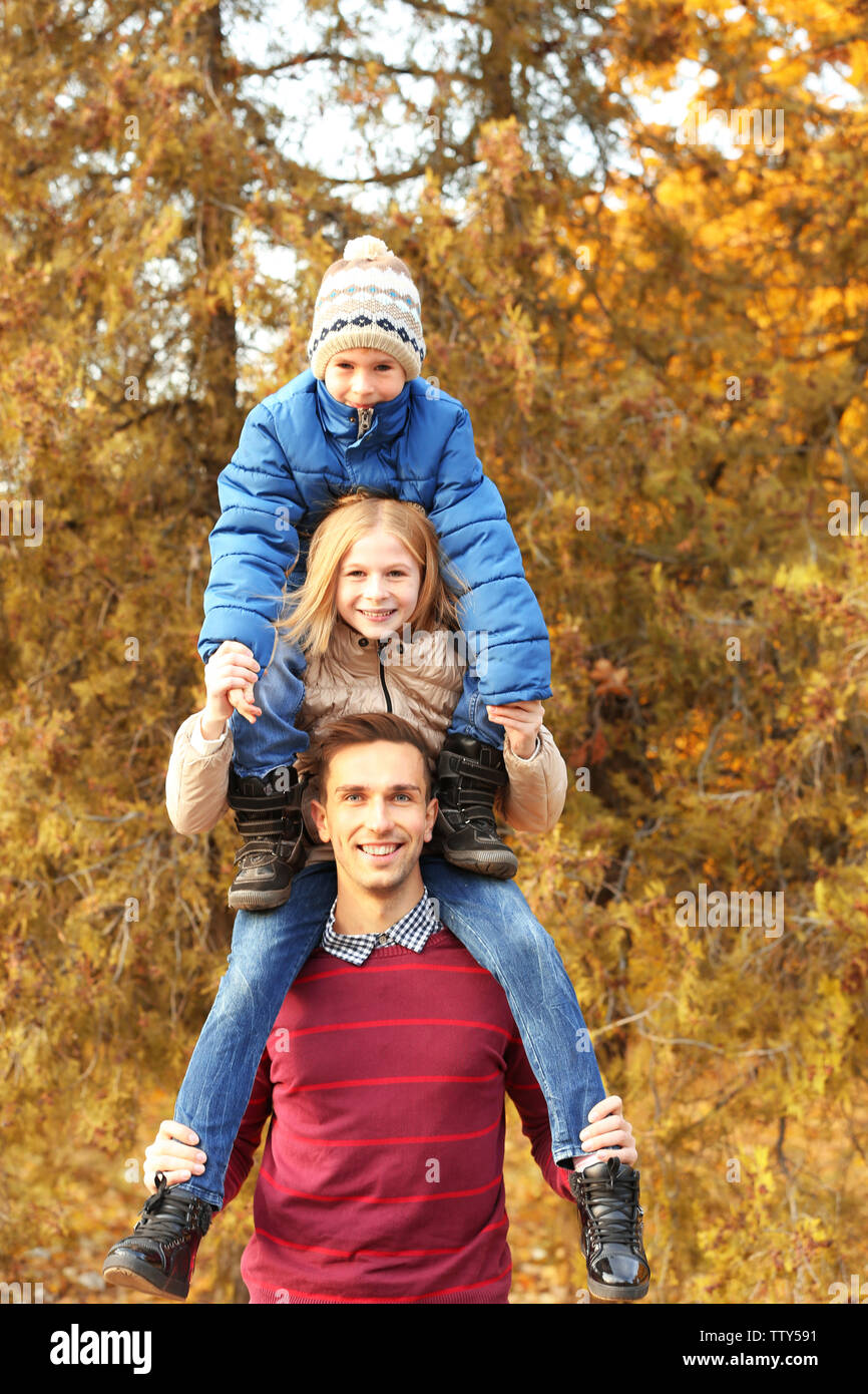 Father and children playing in beautiful autumn park Stock Photo - Alamy