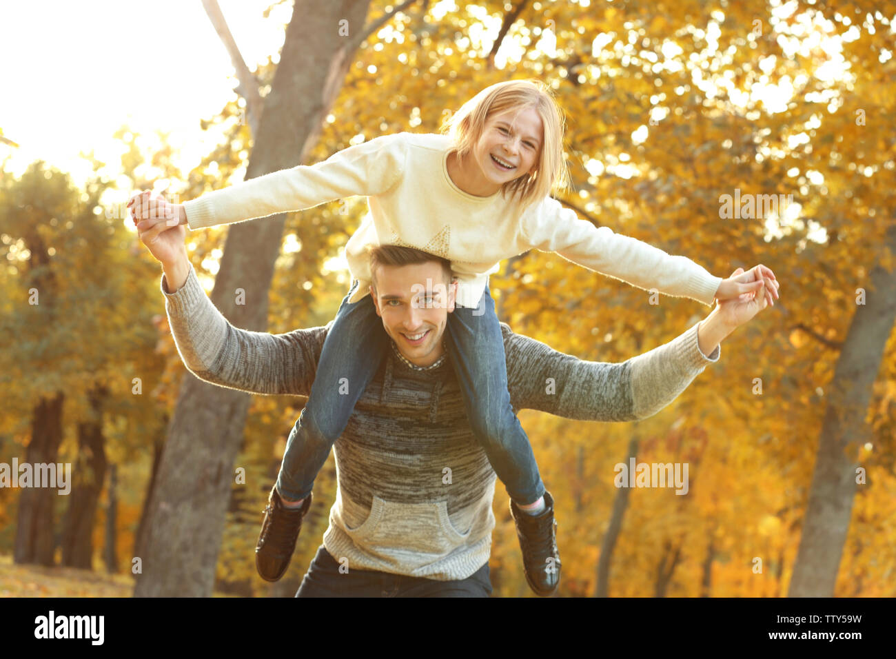 Father and daughter playing in beautiful autumn park Stock Photo - Alamy