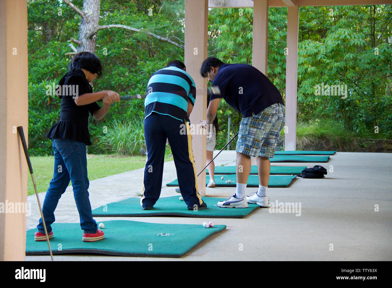 Golfers practicing golf at driving range Stock Photo