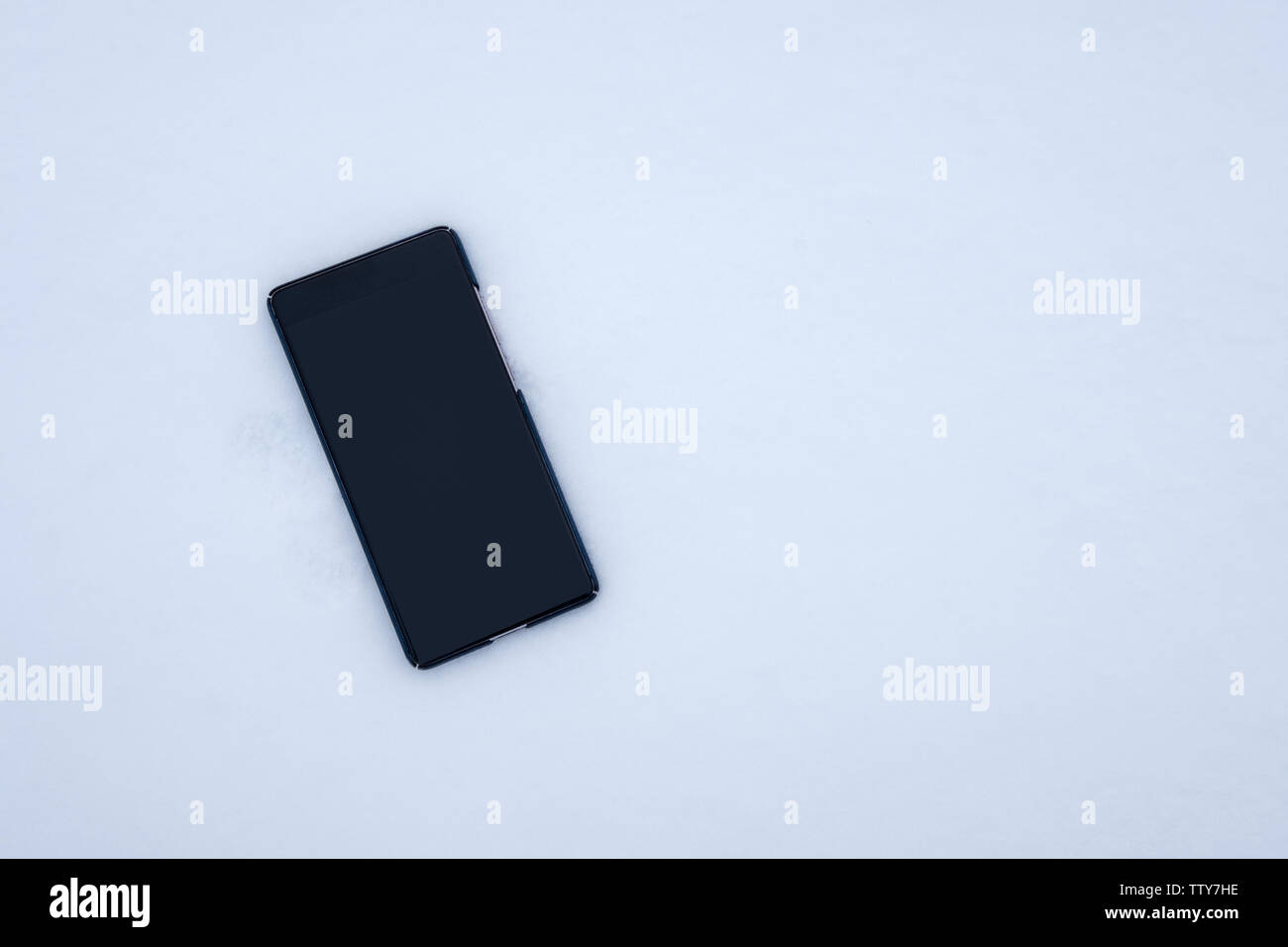 Turn off blank display smartphone falling on snow background Stock ...