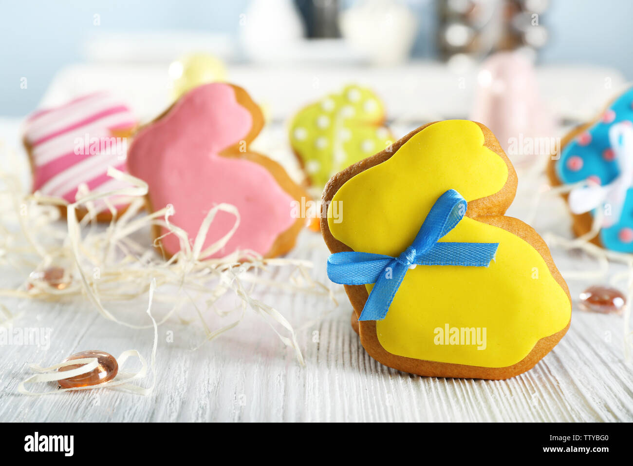 Creative rabbit shape Easter cookie and decorations on wooden table, closeup Stock Photo