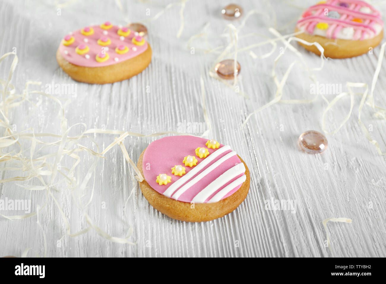 Creative Easter cookies and decorations on wooden table, closeup Stock Photo