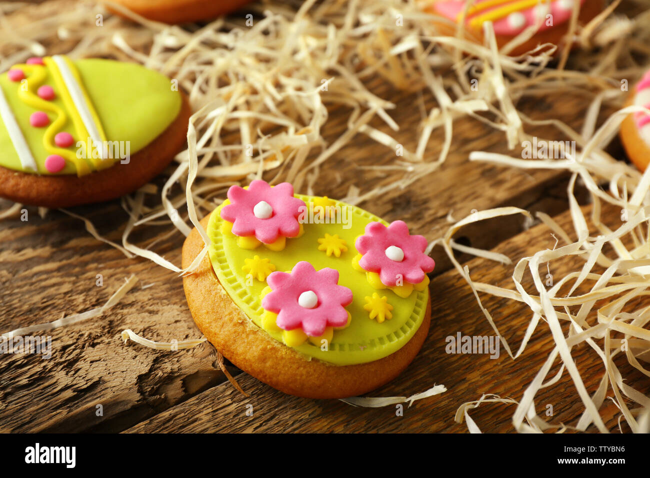 Creative Easter cookies and decorations on wooden table, closeup Stock Photo