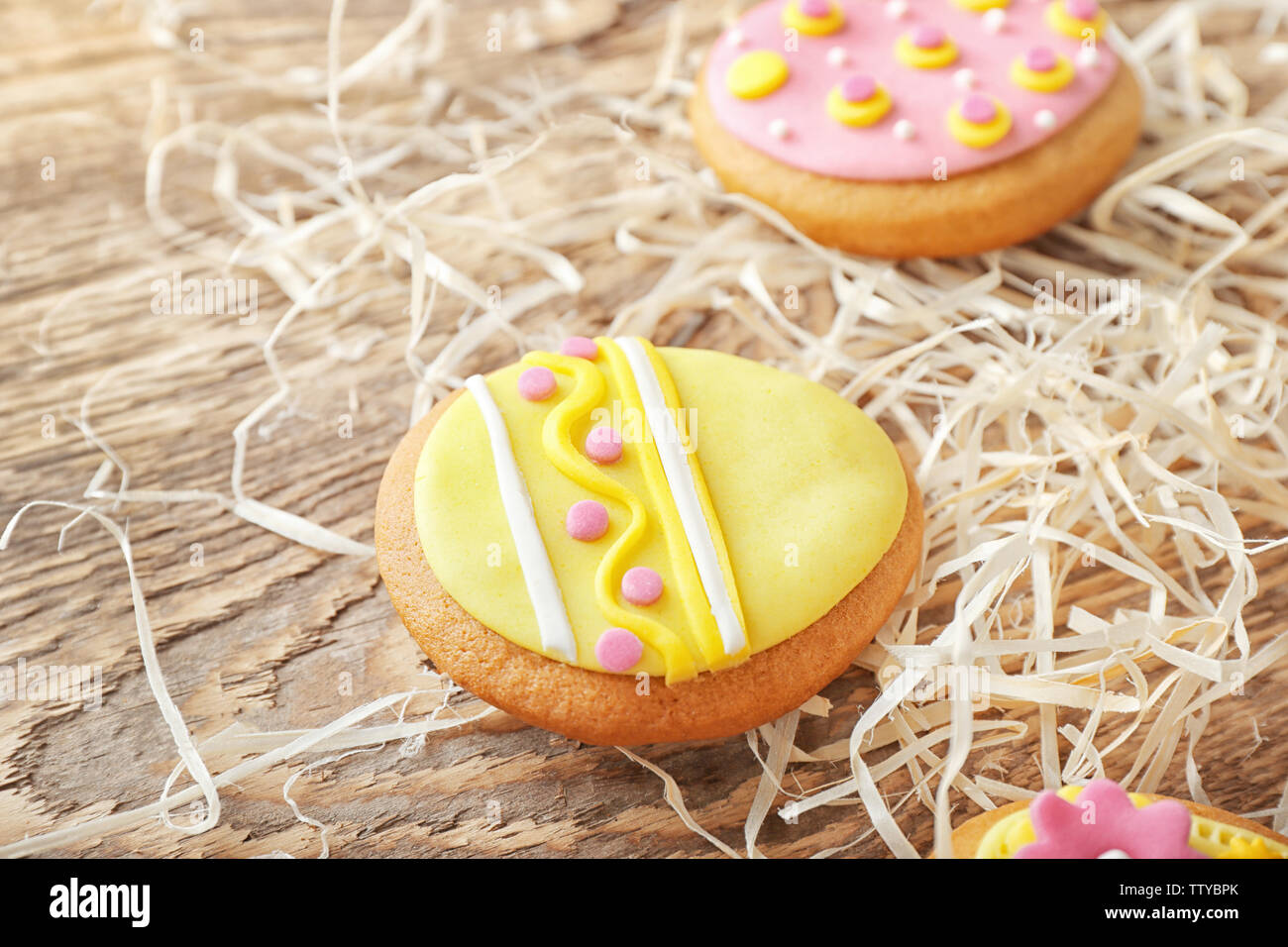 Creative Easter cookies and decorations on wooden table, closeup Stock Photo