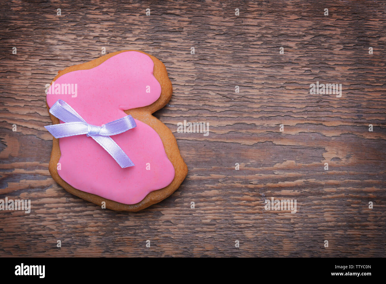 Creative rabbit shape Easter cookie on wooden background Stock Photo