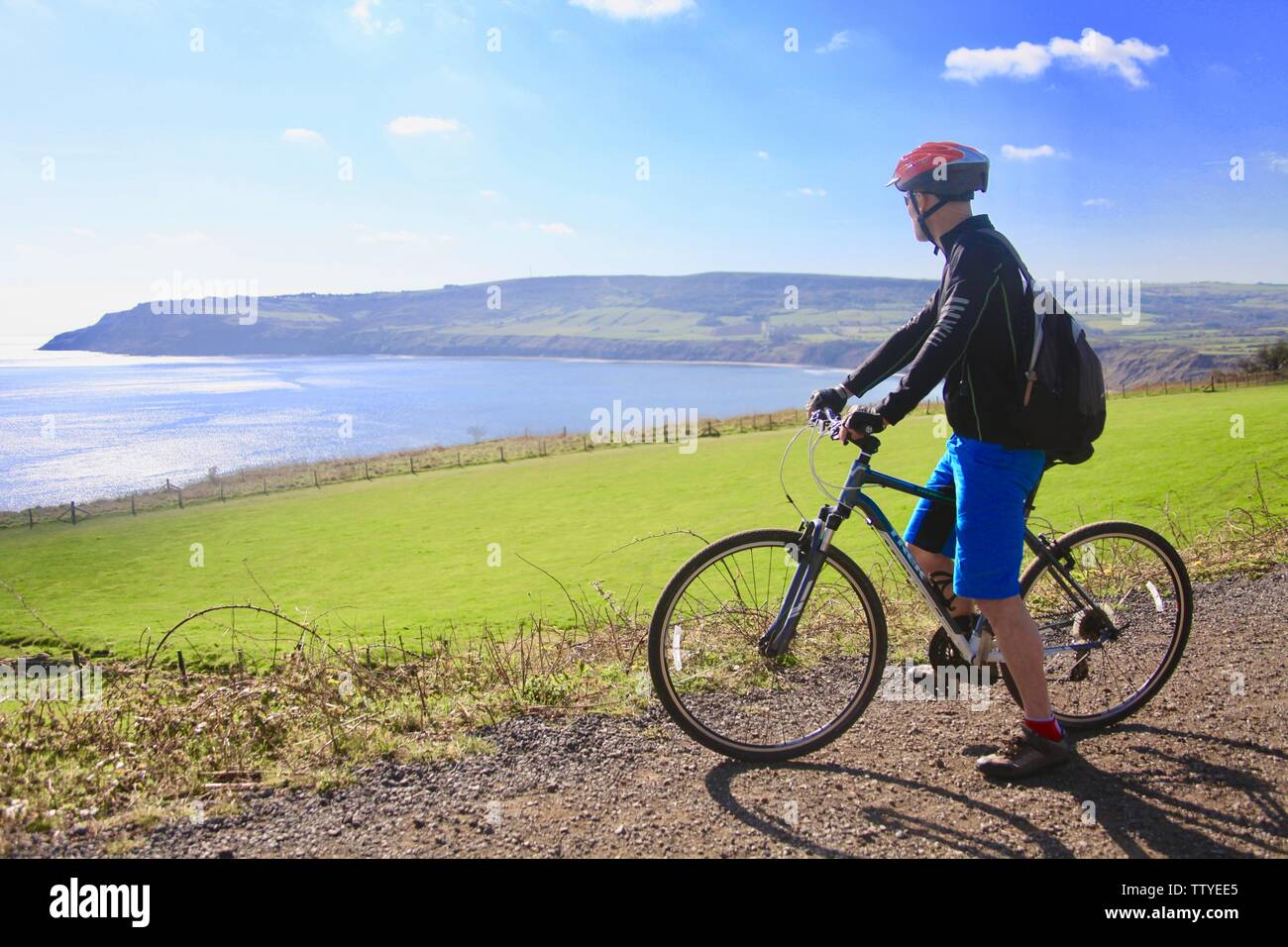 Cycling on Cinder Track, Robin Hoods Bay, Yorkshire. The Cinder Track is a 21-mile car-free bike track between Scarborough and Whitby, Stock Photo