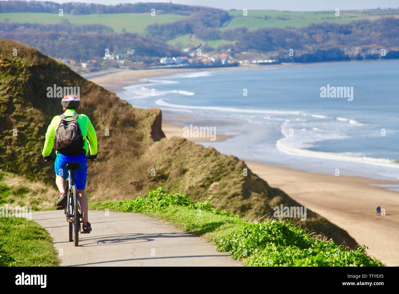 Cycling on North Yorkshire coast between Whitby and Sandsend Stock Photo