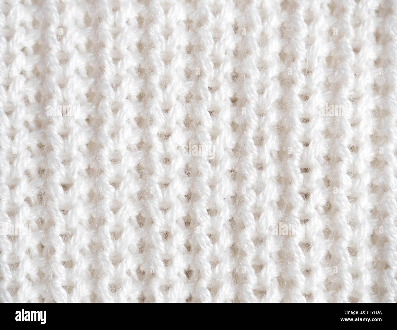 Knitted loops background. Part knitted sweater. Knitted texture. White Knitted Fabric Texture. White knitting wool texture background. Wool sweater Stock Photo