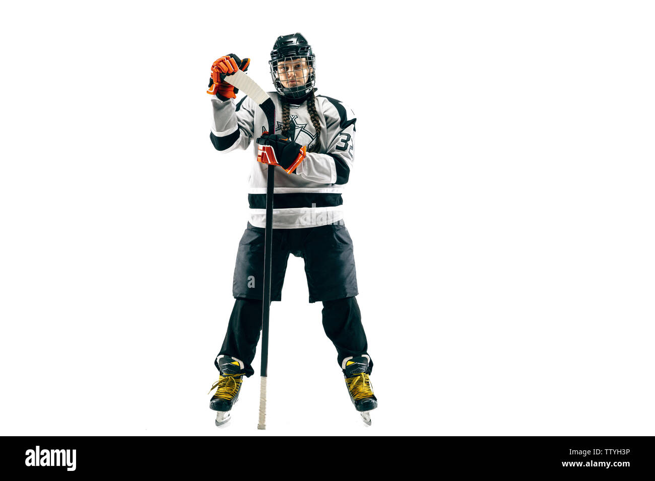 Young female hockey player isolated on white background ...