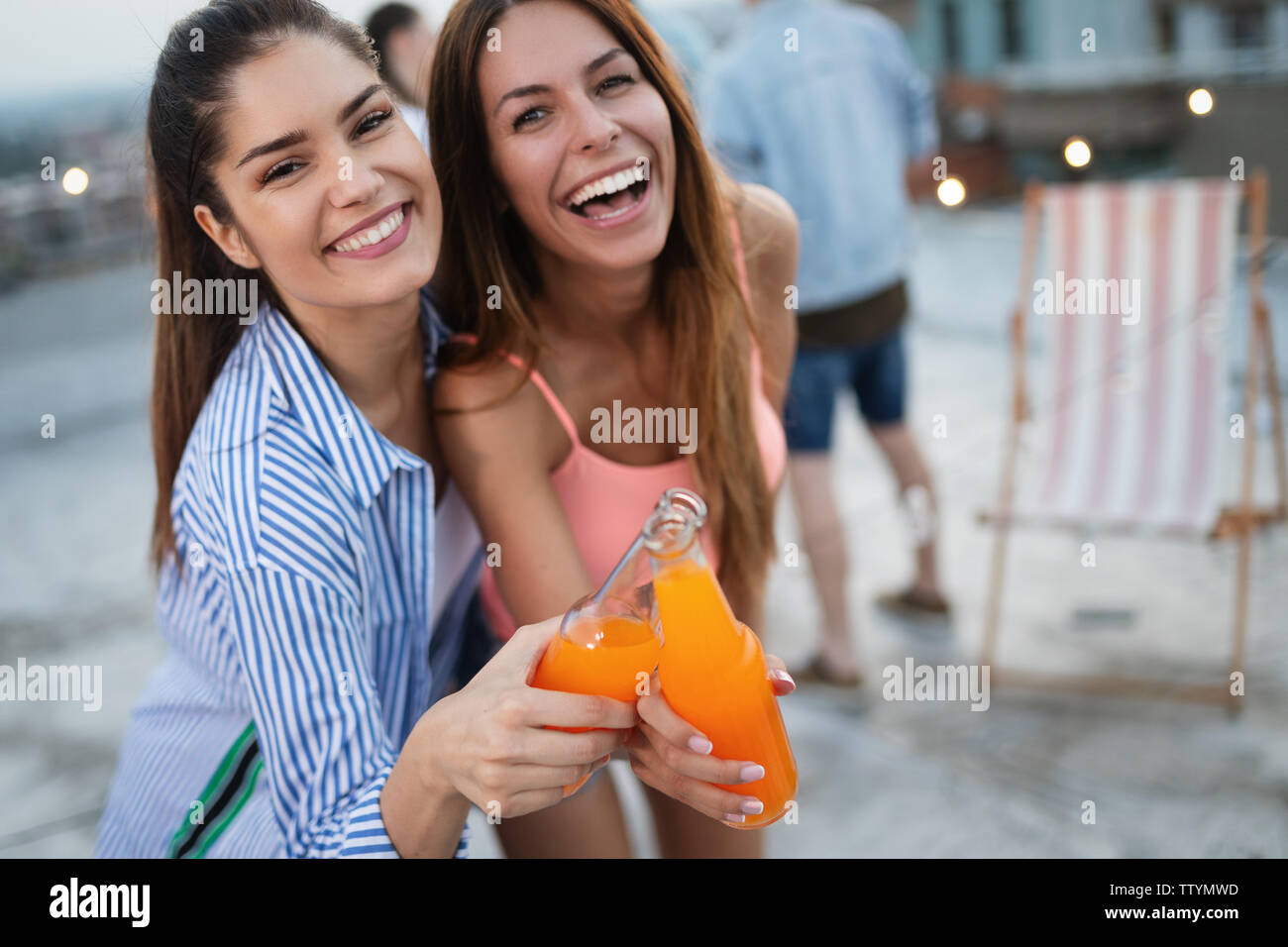 Happy young girls having fun at party Stock Photo - Alamy