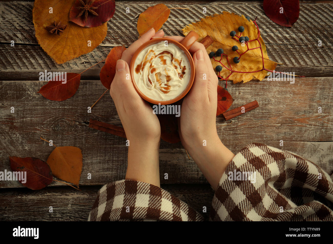 Female hands holding cup with hot drink on wooden background Stock ...