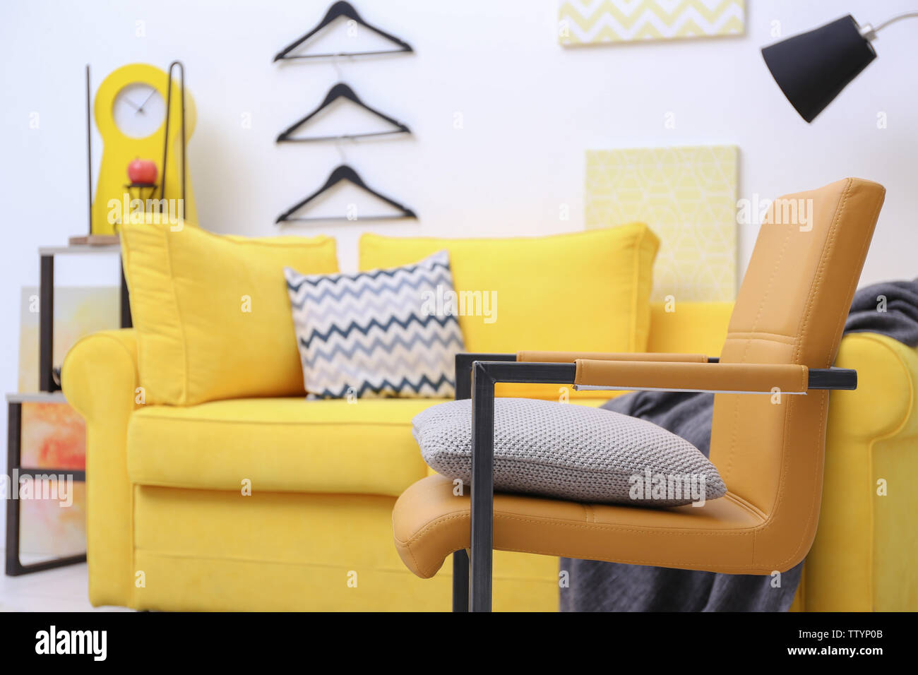 Modern living room interior with yellow sofa Stock Photo - Alamy