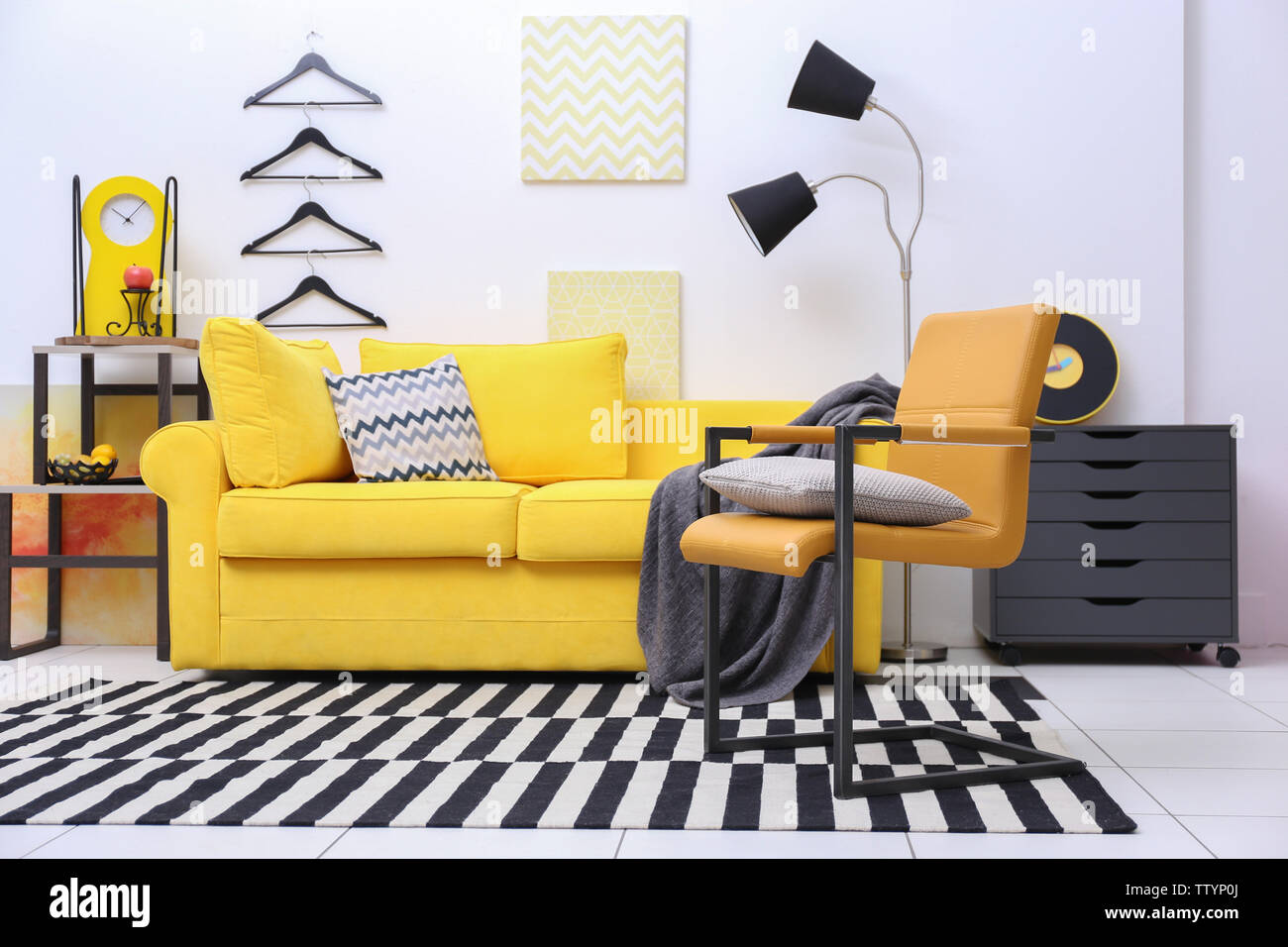 Modern living room interior with yellow sofa Stock Photo - Alamy
