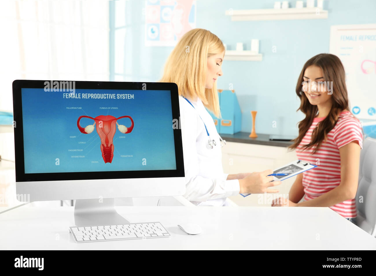 Computer at hospital on blurred gynecologist and woman background Stock ...