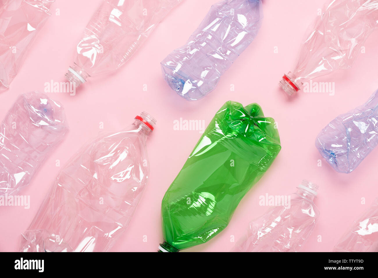 Plastic bottles on pink background top view. Plastic recycling concept. Stock Photo