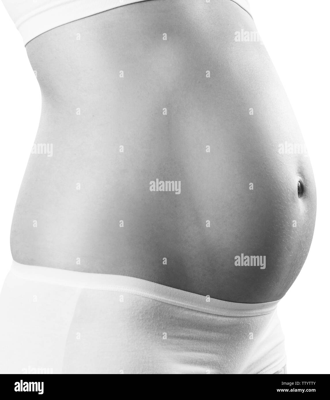 Pregnant woman with belly in the early stages of pregnancy. Stock Photo