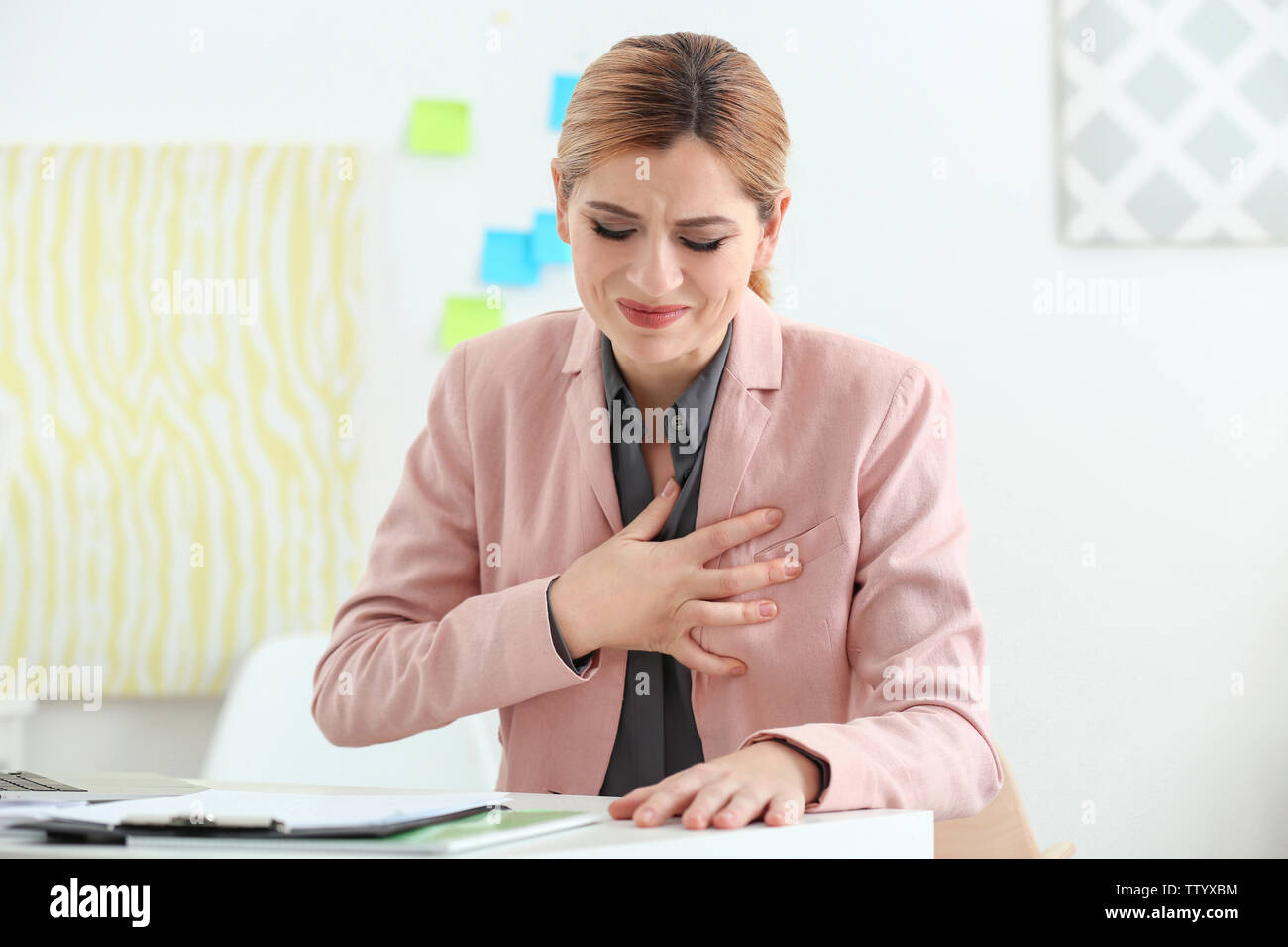 Beautiful woman suffering from heartache in office Stock Photo