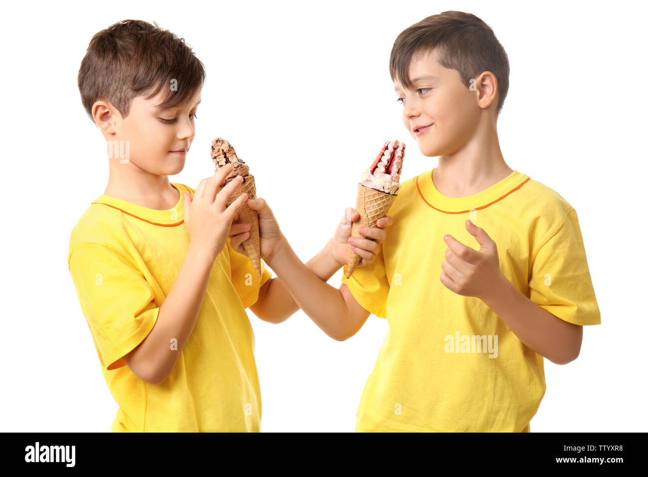 Cute boys with ice cream on white background Stock Photo