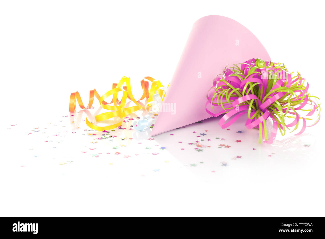 Party hat and colorful confetti on white background Stock Photo - Alamy