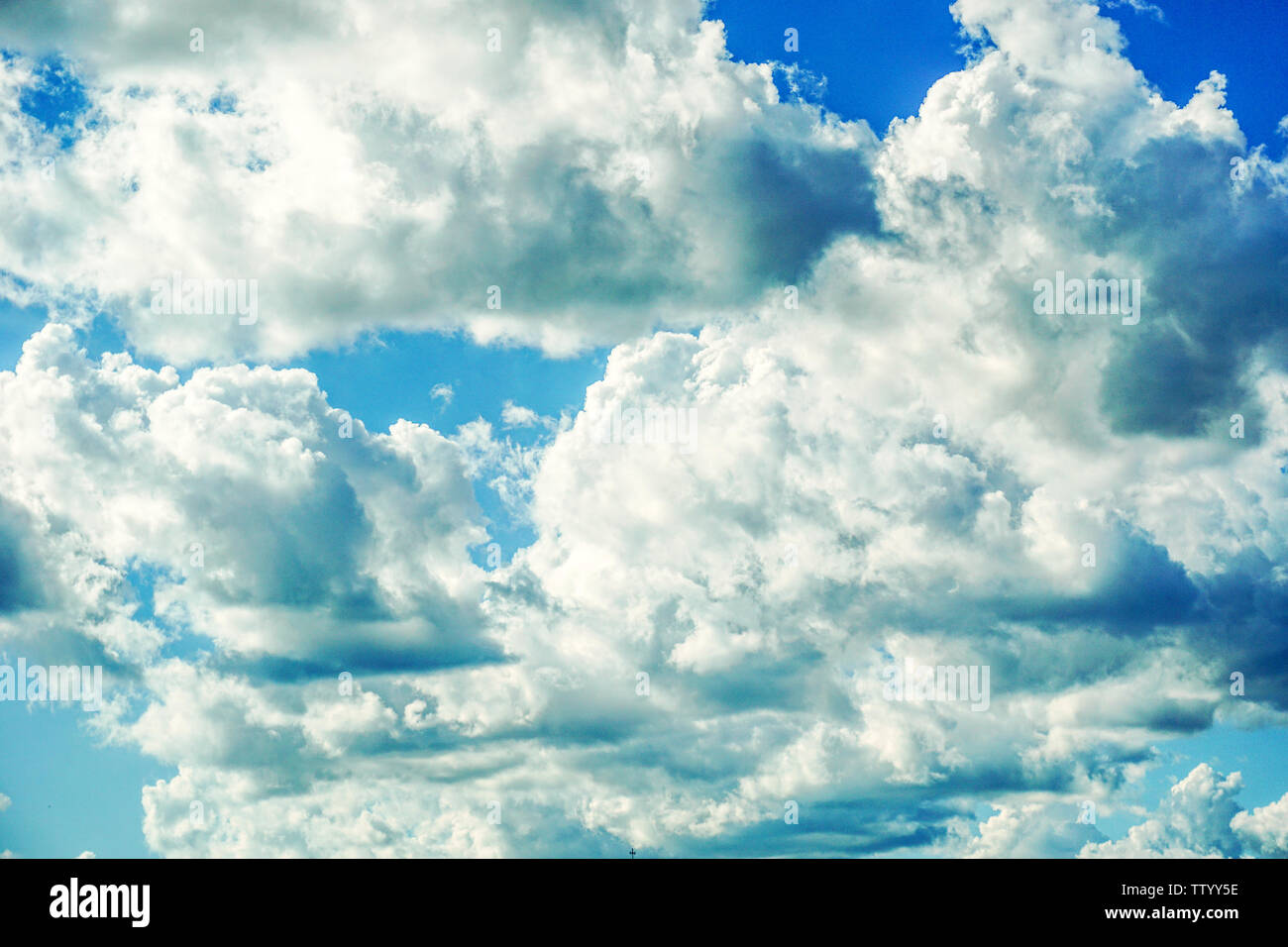 Blue sky background with fluffy clouds Stock Photo - Alamy
