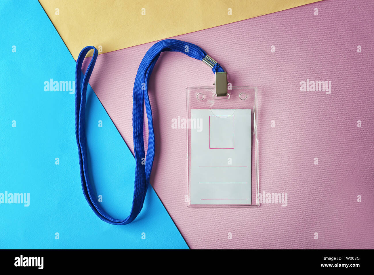 Blank badge with lanyard on color paper background Stock Photo - Alamy