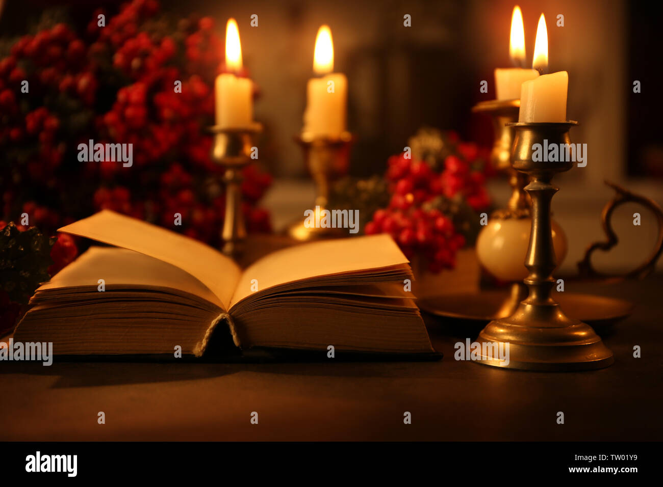 Open Bible and burning candles on table Stock Photo Alamy