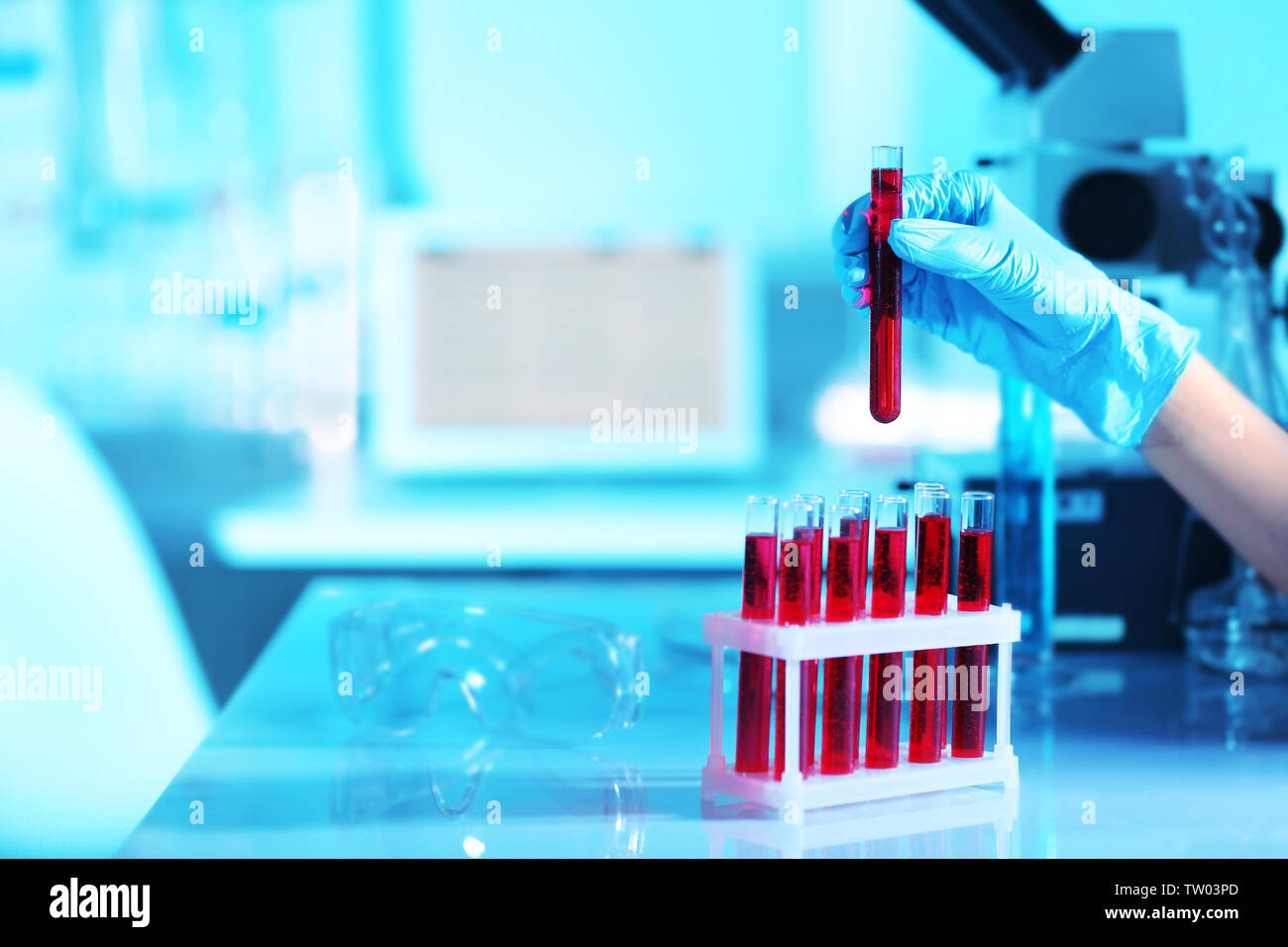 Scientist hand and test tubes with blood in laboratory Stock Photo - Alamy