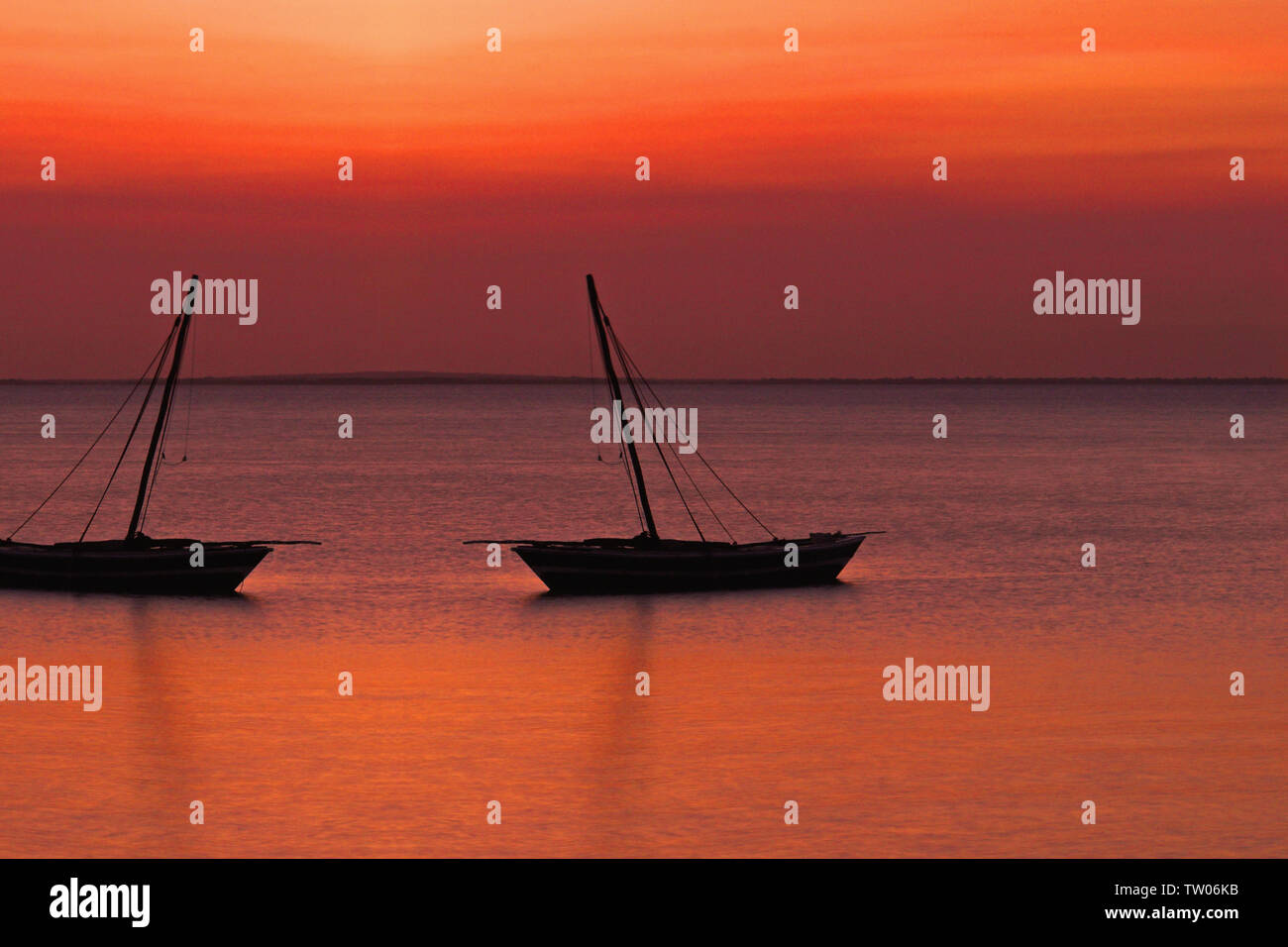 Silhouette of boats at sunset Stock Photo - Alamy