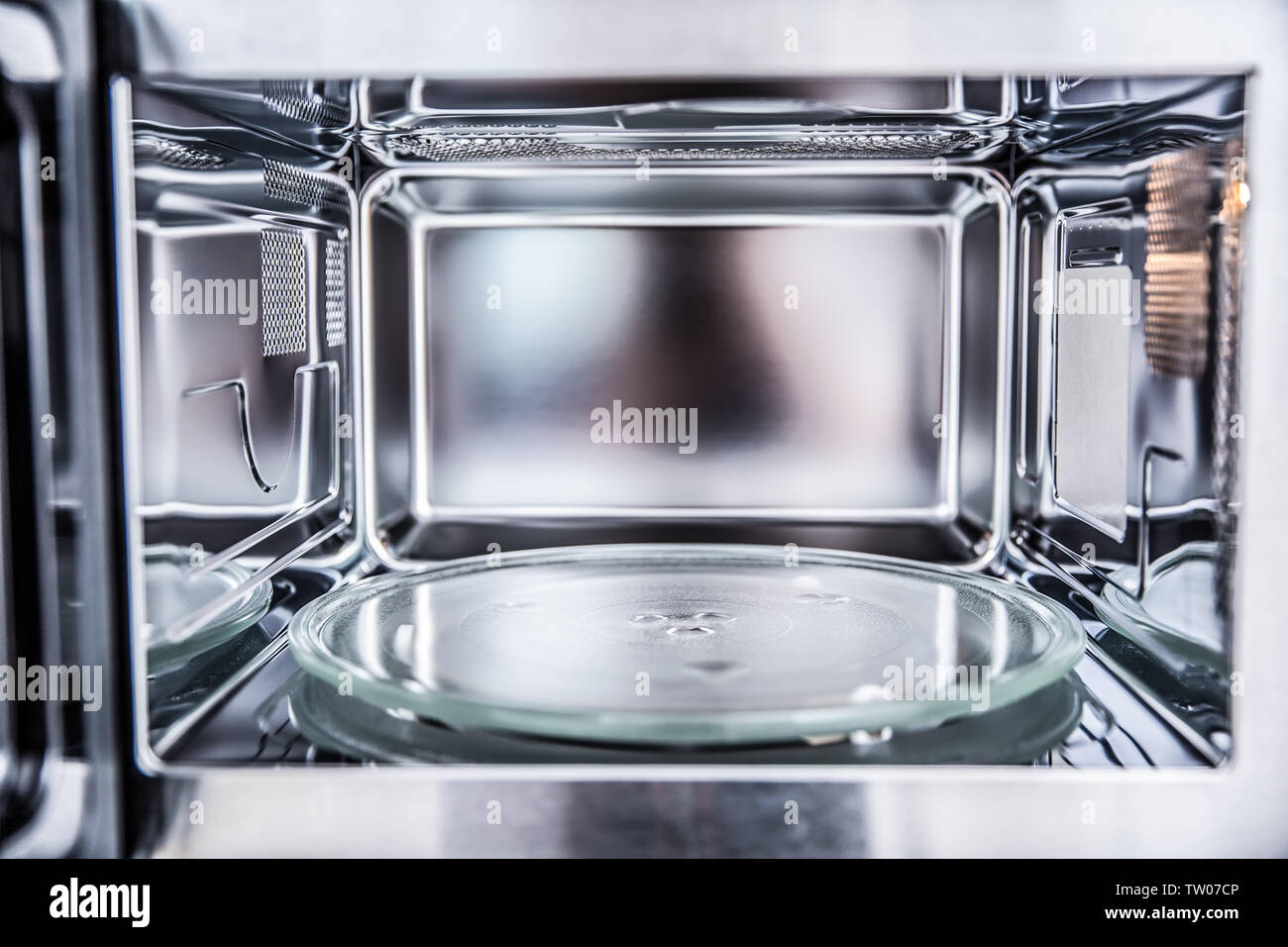 Inside view of new clean staniless, empty microwave oven Stock Photo