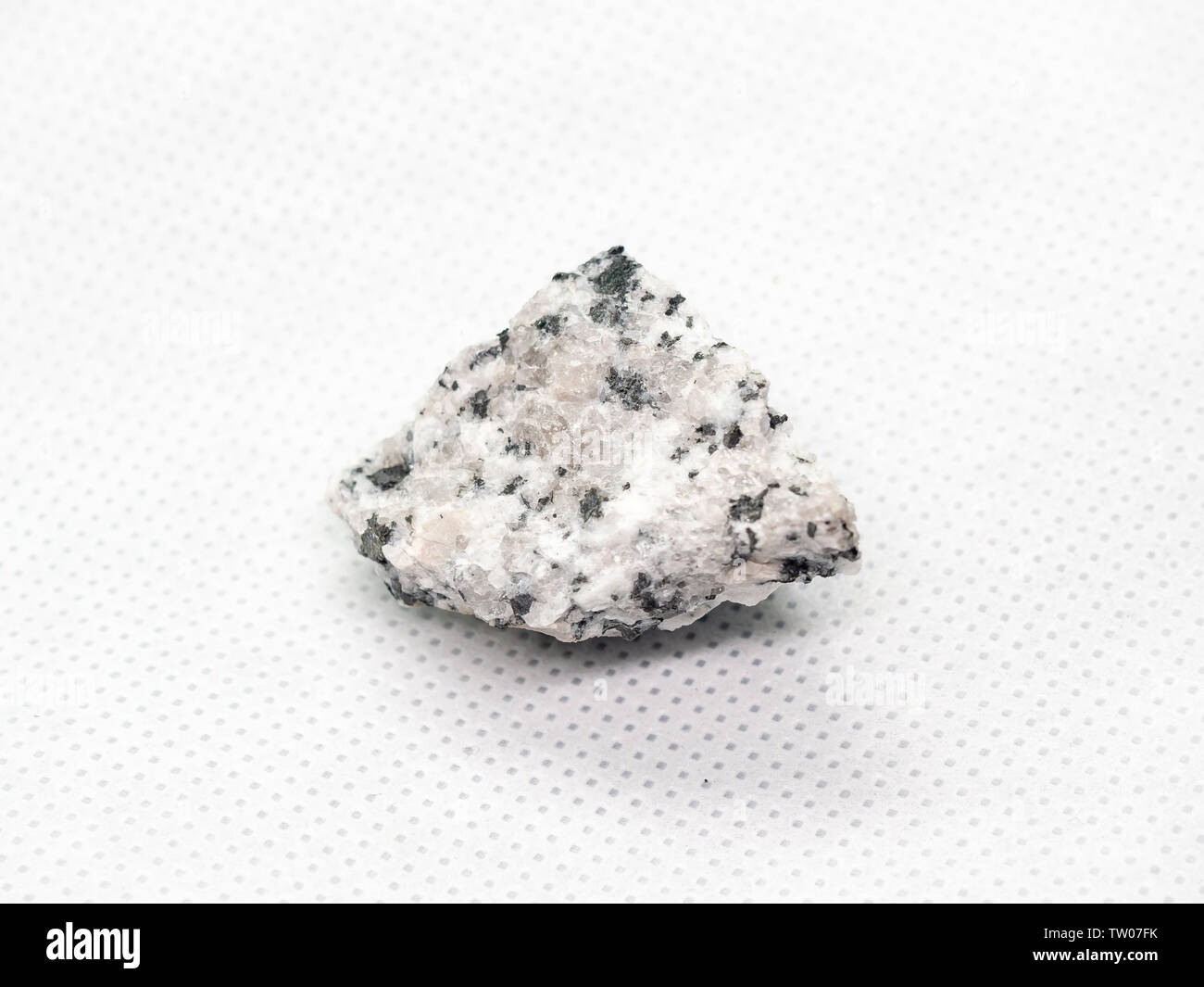 Geological specimen of natural white layered mineral Sanidine - semiprecious stone, on white background Stock Photo