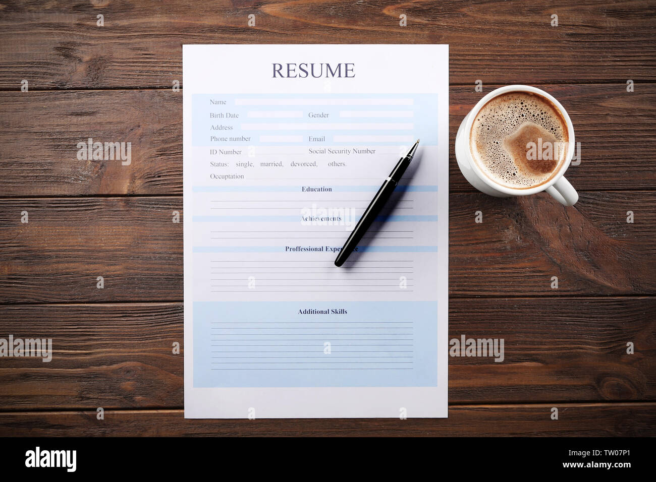 Cup of coffee and resume form on - Cup Of Coffee And Resume Form On Wooden Background TW07P1 
