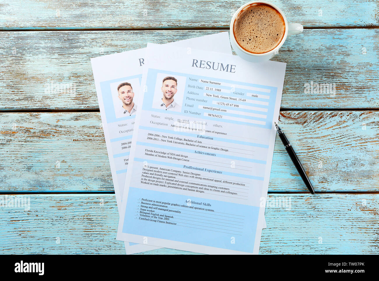 Cup of coffee and completed resume - Cup Of Coffee And Completed Resume Forms On Wooden Background TW07PK 