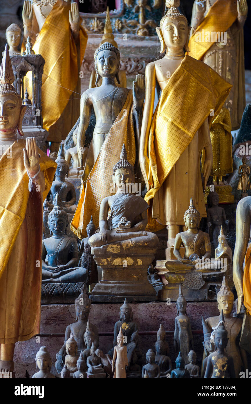 Buddha statues in the Pak Ou Caves, filled with hundreds of Buddhist figures, on the Mekong River near the town of Luang Prabang, Laos. Stock Photo