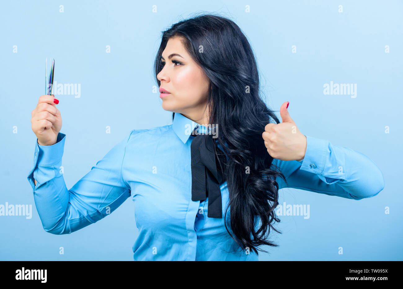 Girl makeup face hold tweezer for eyelash extension. Makeup false lashes volume. Lash applicator