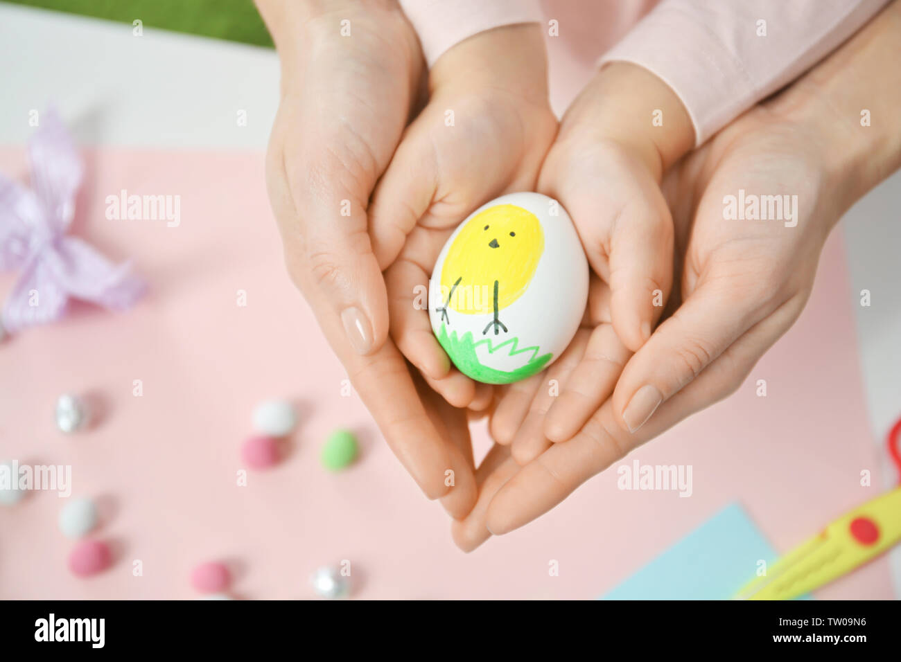 Mother and daughter holding decorated Easter egg Stock Photo