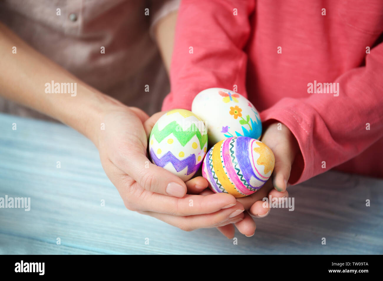 Mother and daughter holding decorated Easter eggs Stock Photo