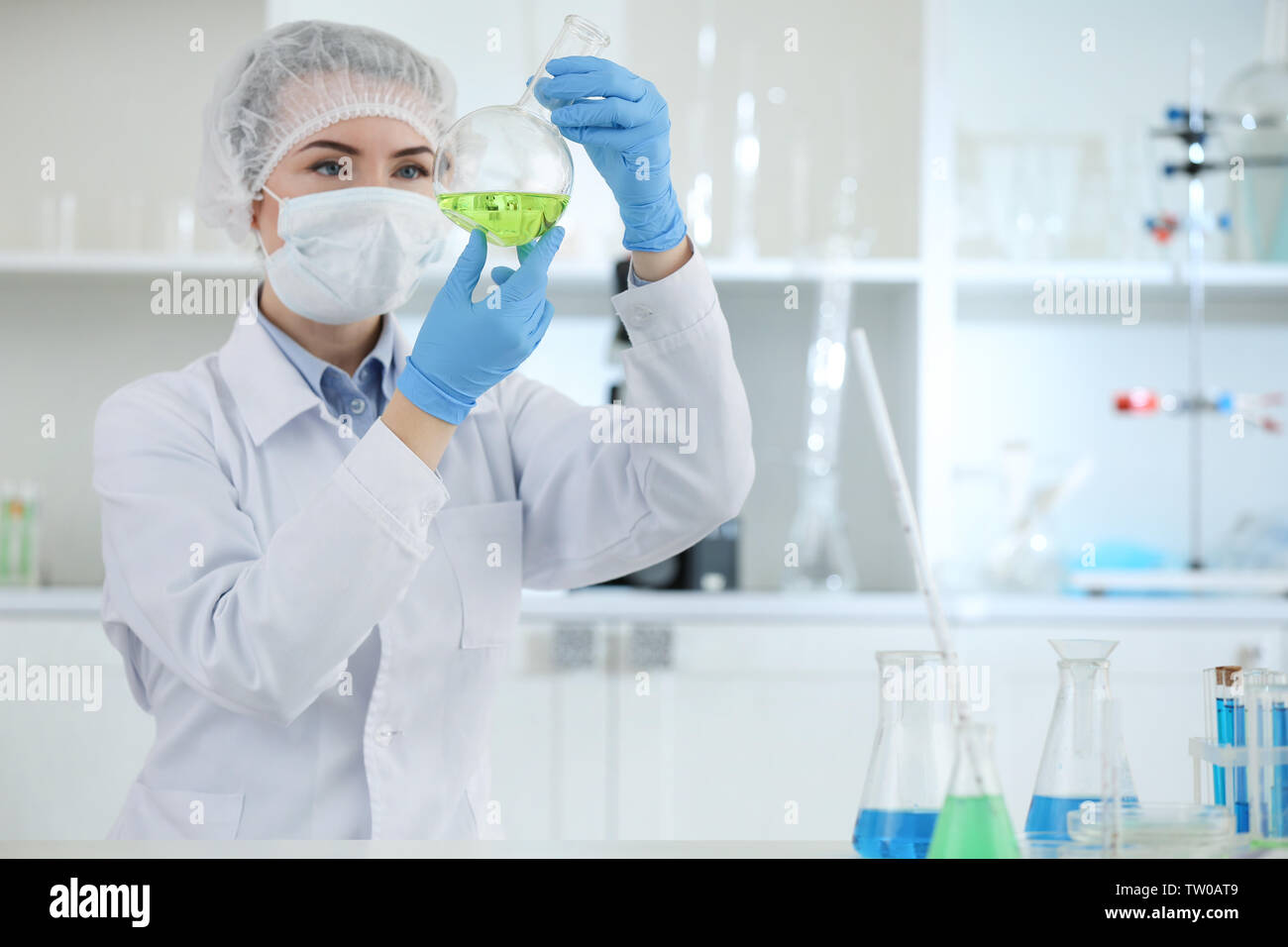 Scientist holding test flask with sample in laboratory Stock Photo - Alamy