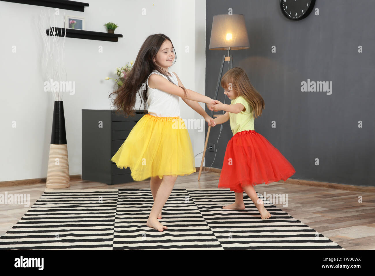 Cute little sisters dancing in the room Stock Photo Alamy
