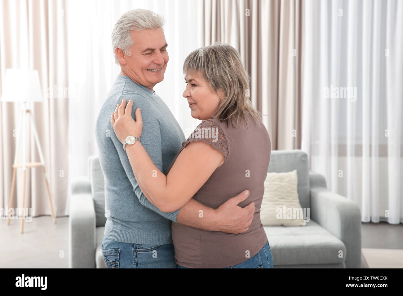 Middle aged couple dancing in the room Stock Photo