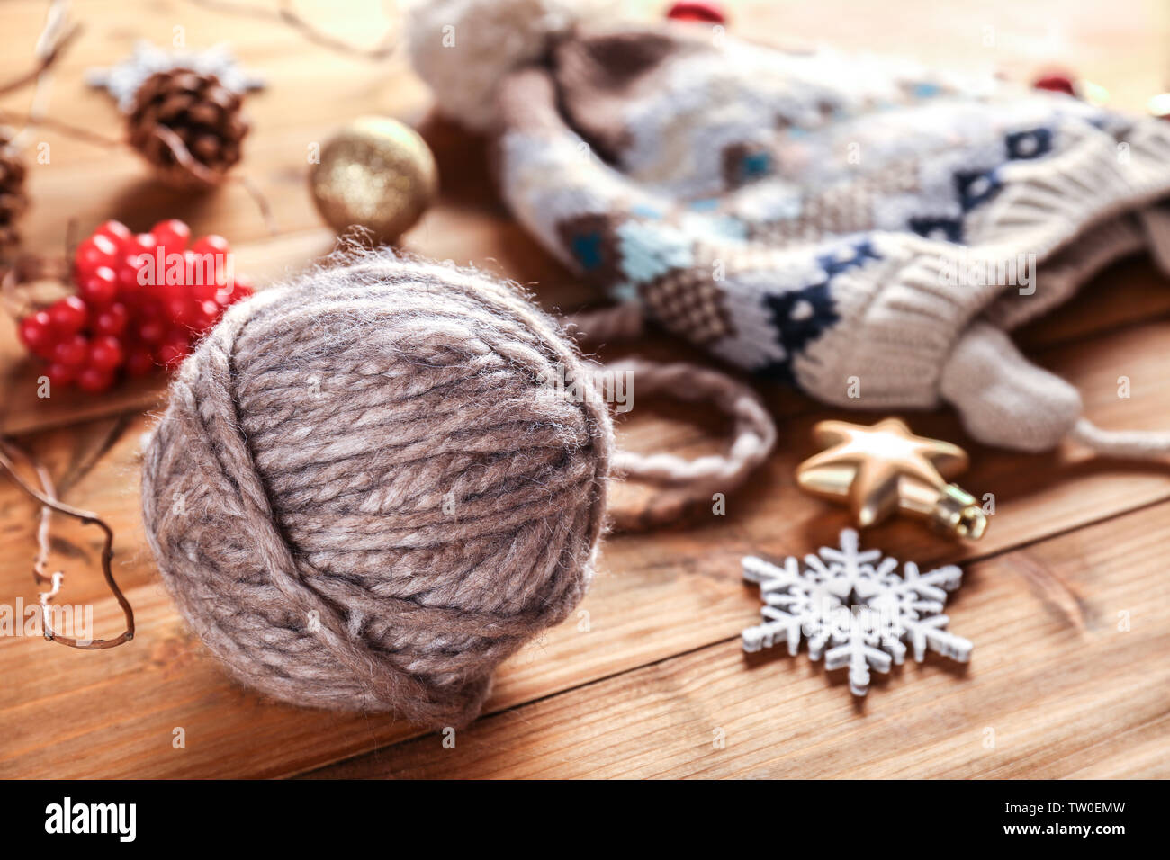 Yarn Ball Knitted Hat And Christmas Decorations On Wooden Table