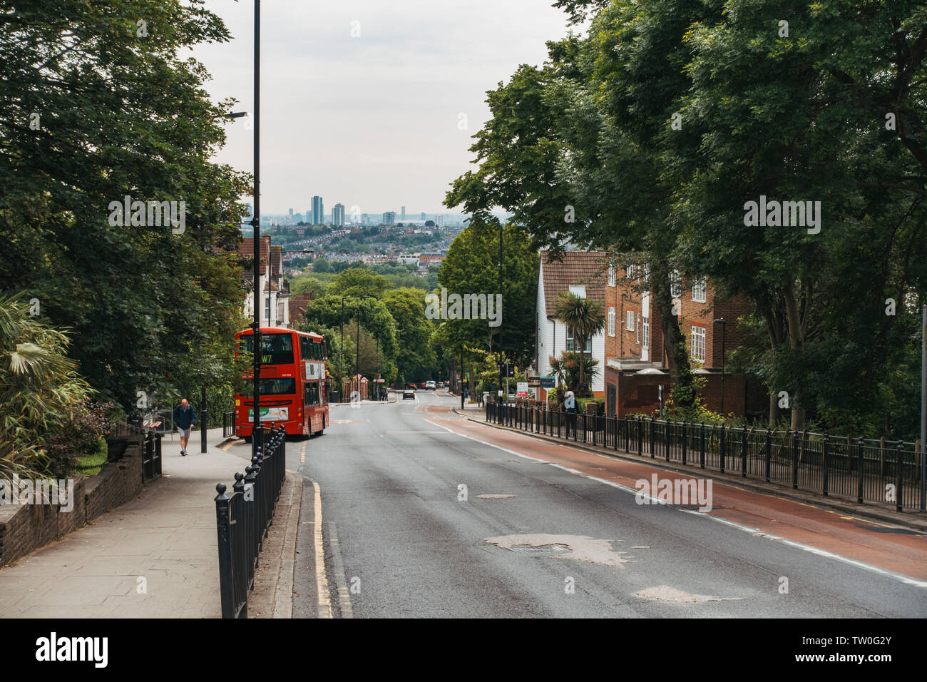 A double decker bus pulls out from a stop in Muswell Hill, North London. Stock Photo