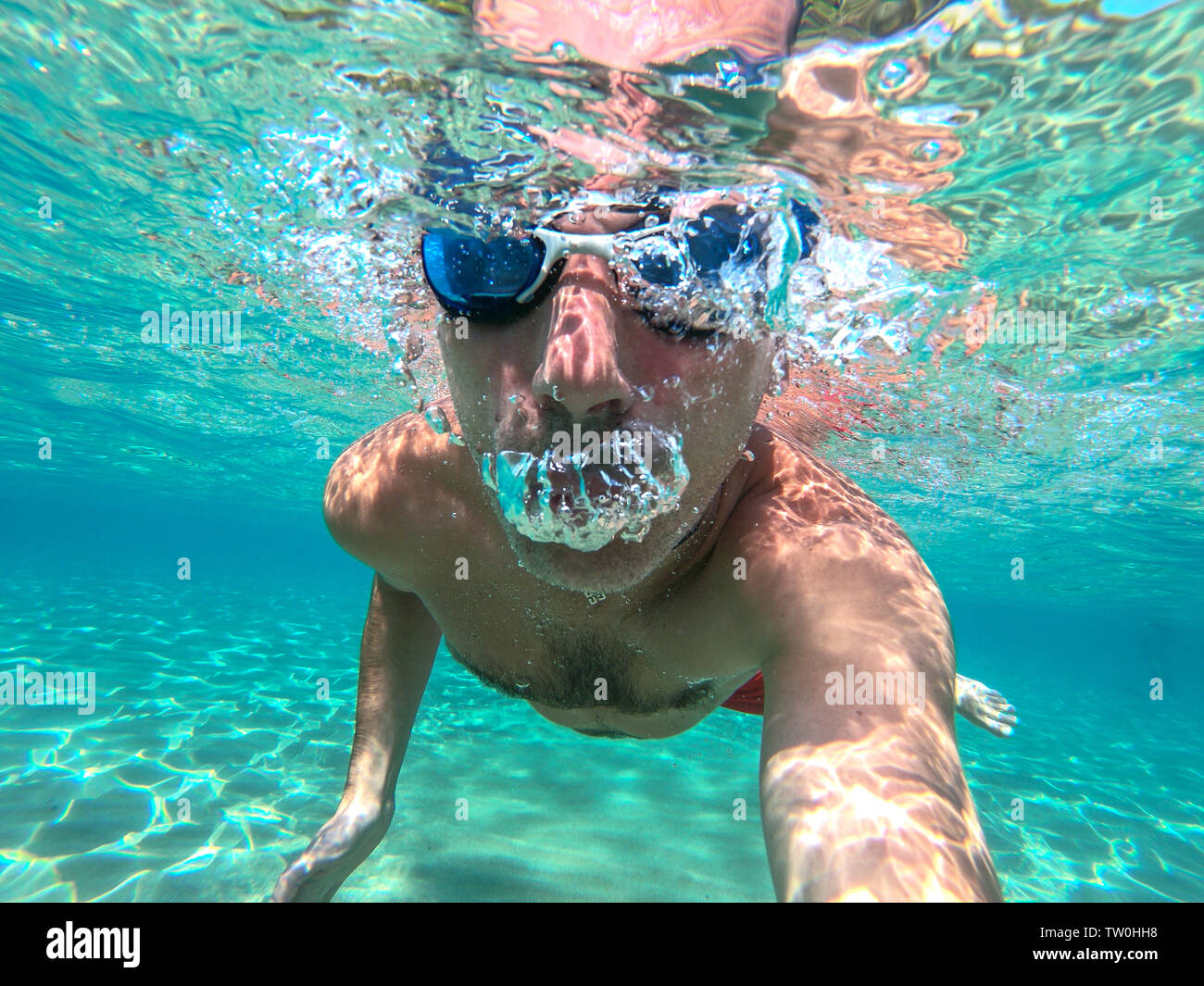 Funny guy having fun and taking underwater selfie while swimming in the sea Stock Photo Alamy