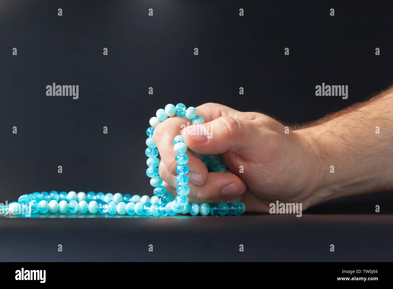 Male hand holding beads Stock Photo