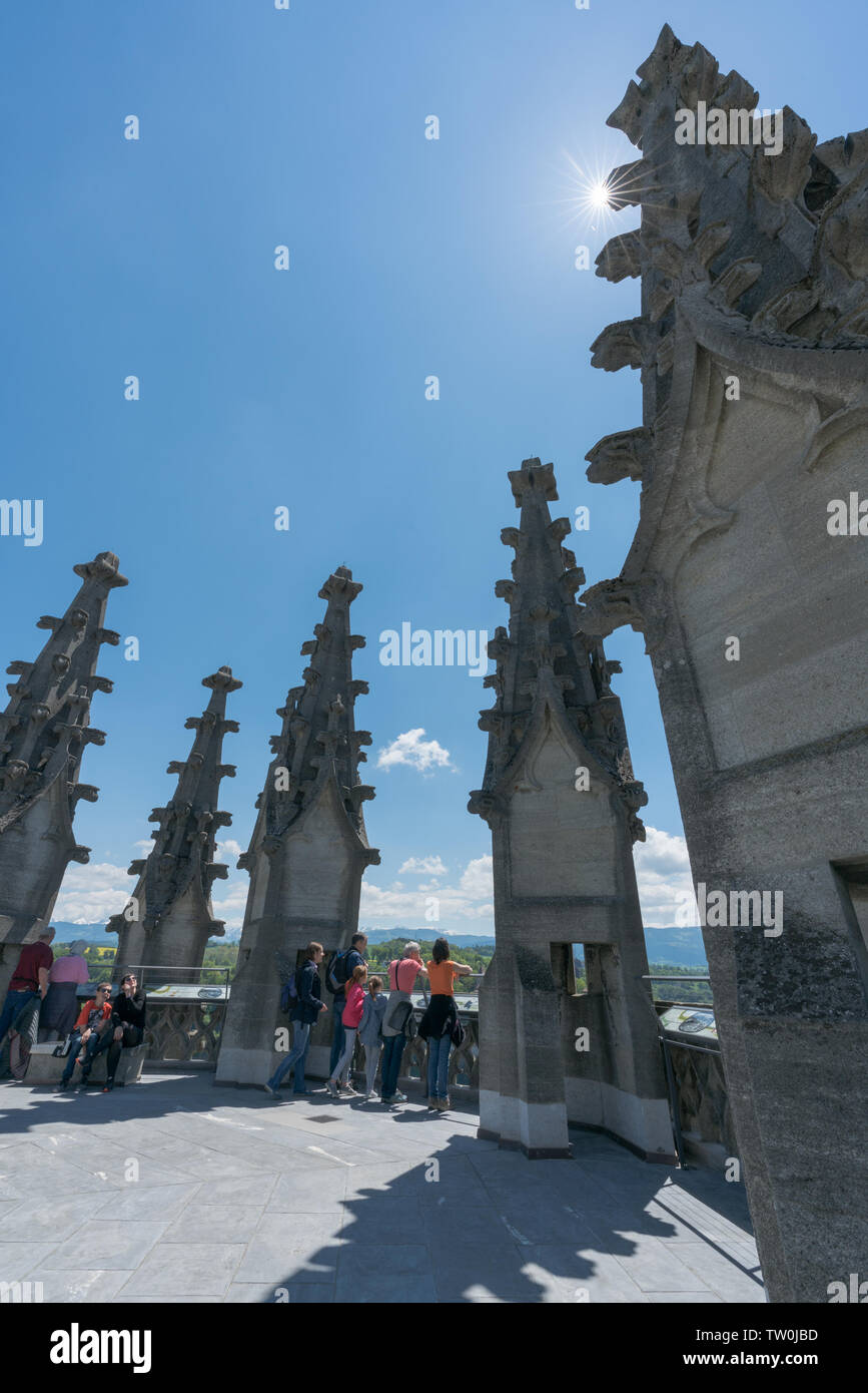 Fribourg, FR / Switzerland - 30 May 2019: many tourists enjoy the view from the top of the bell tower of St. Nikolaus cathedral over the historic city Stock Photo