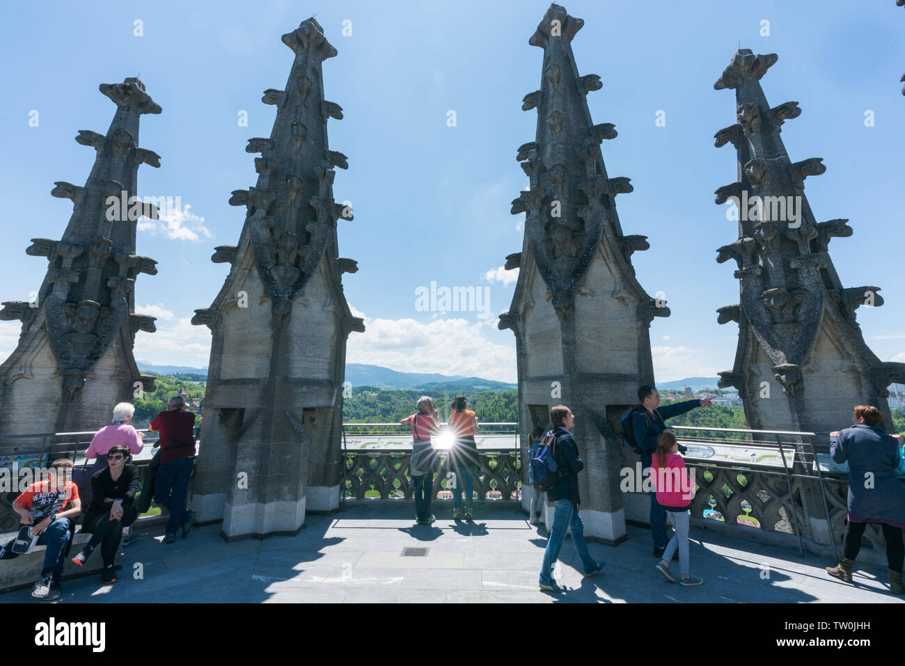 Fribourg, FR / Switzerland - 30 May 2019: many tourists enjoy the view from the top of the bell tower of St. Nikolaus cathedral over the historic city Stock Photo